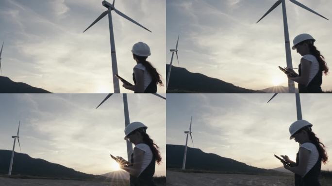 一位女工程师在风力发电场工作，在一台强大的风力涡轮机附近的平板电脑上分析指标并收集数据。可再生能源在