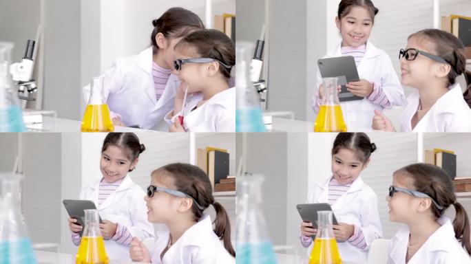 可爱的小学女生穿着实验服在学校实验室学习化学，用记事本技术记录例子和分析，在科学课上混合液体，教育和