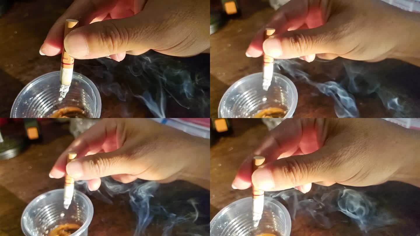 抽香烟男子抽烟的手拿香烟手吸烟吸香烟烟灰