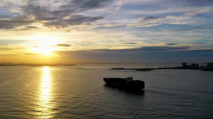 航拍集装箱货轮进港口码头青岛港日落夕阳