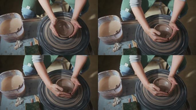 年轻艺术家在陶艺工作室用她的双手制作碗，手工创作艺术家，小生意