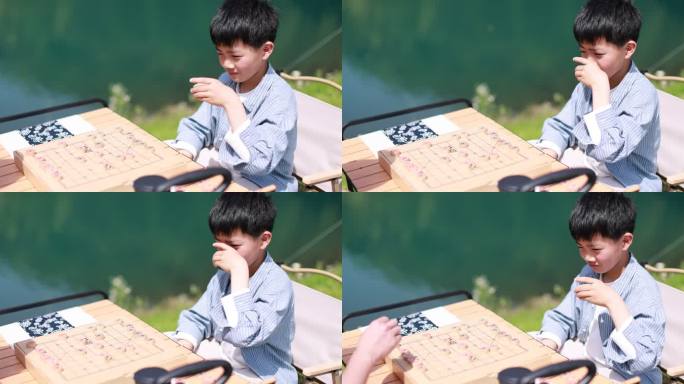 在湖边下棋的中国男孩慢镜