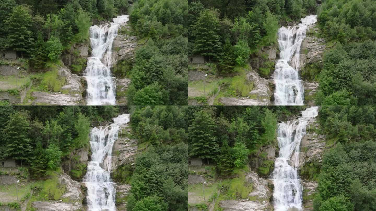 空中无人机看到的瀑布(cascata piumogna)被郁郁葱葱的绿树包围