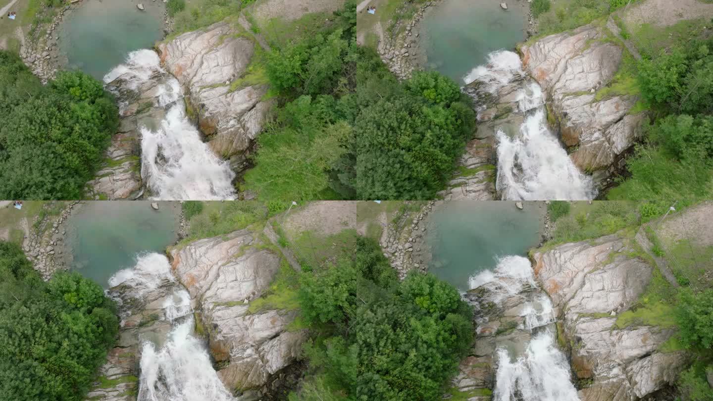 空中无人机看到的瀑布(cascata piumogna)被郁郁葱葱的绿树包围
