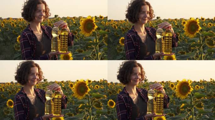 女人捧着几瓶葵花籽油在盛开的田野上微笑着。收获向日葵，装油