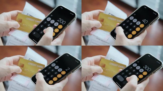 网上购物后用手机按发票计算器的女人的手查看收据和信用卡的手特写你正在使用app通过手机app管理费用