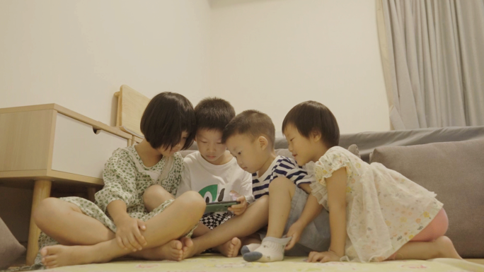 四个小朋友在家玩手机游戏
