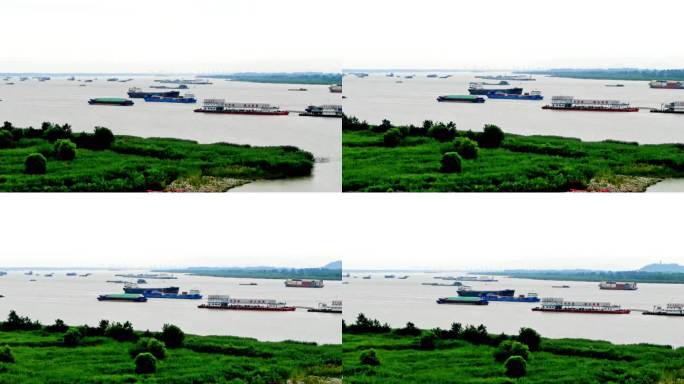 航拍轮船货轮航行长江江边堤岸