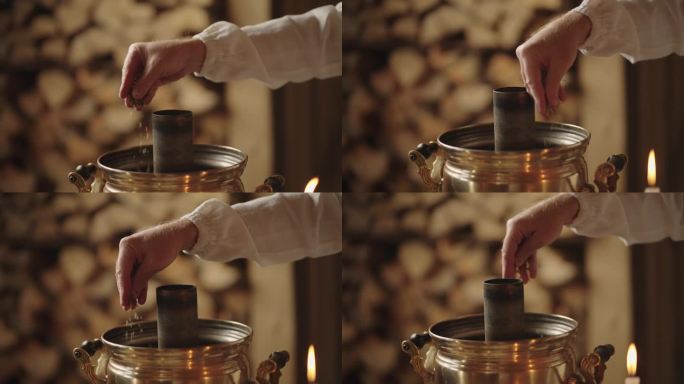 老俄罗斯风格的传统茶道，男子在茶炊中将草药倒入水中，特写