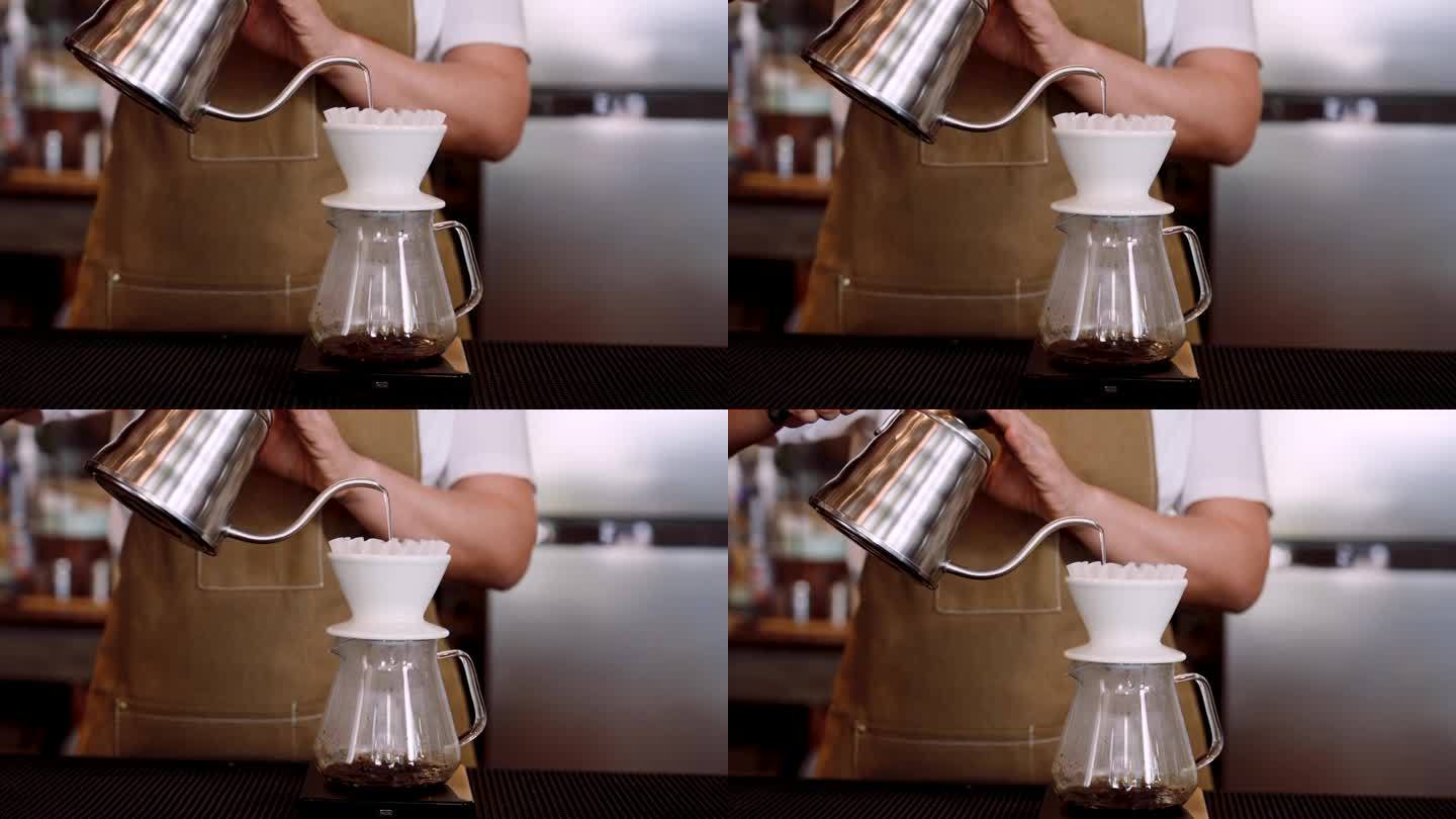 特写:咖啡师手拿水壶举起来倒咖啡粉，地址在滴漏咖啡装置中，一边喝煮好的咖啡，一边倒入热水，旋转着制作