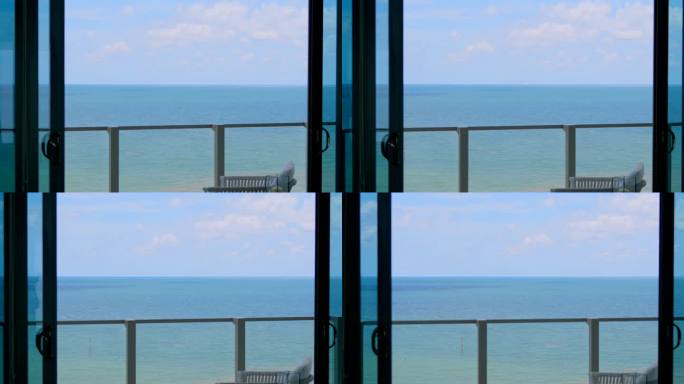 壮观的景色在海洋天际线通过全景窗口壮丽的公寓与夏季露台在迈阿密。南佛罗里达豪华度假胜地的夏日蓝天