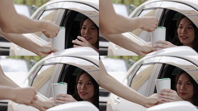 美丽的亚洲女性在开车通过或开车经过点餐后，会收到个性化的咖啡杯或咖啡杯。