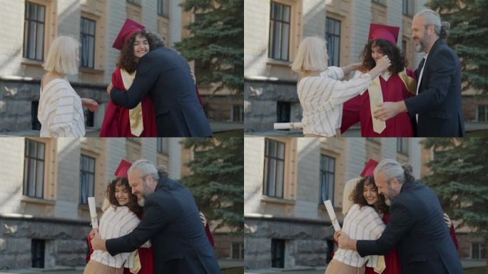 骄傲的父母在大学校园里拥抱笑着祝贺女儿毕业