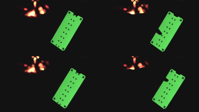 男子使用智能手机色度键篝火露营地