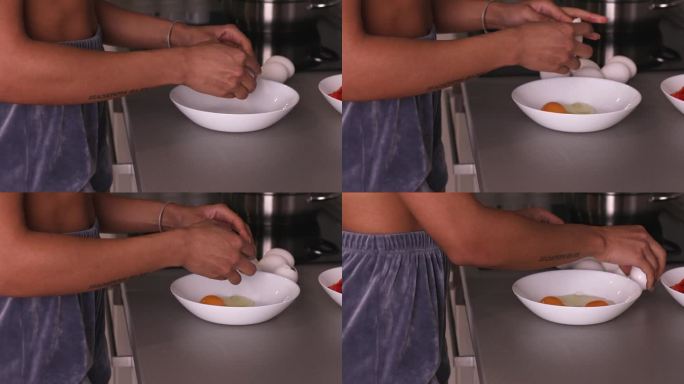 女人把鸡蛋敲进碗里，露出蛋黄。在家做饭和自制饭菜的概念。