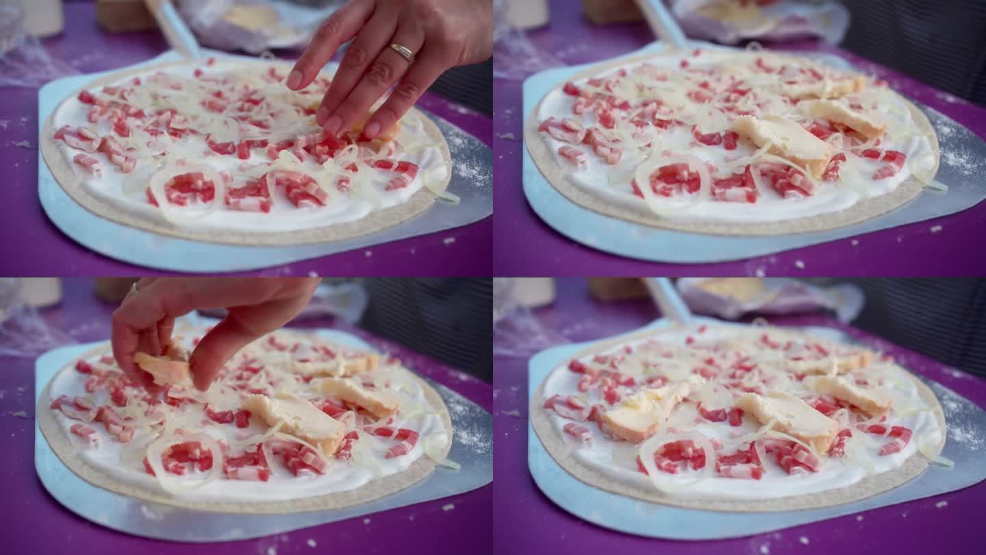 Tarte Flambee的制作是一种来自阿尔萨斯的法国披萨，由一层非常薄的糕点制成，上面覆盖着酸奶