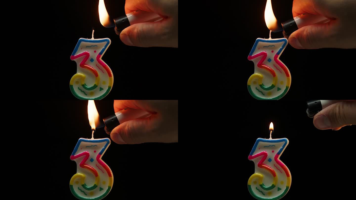 在黑色背景上用慢动作吹灭3号蜡烛的特写。三岁生日。
