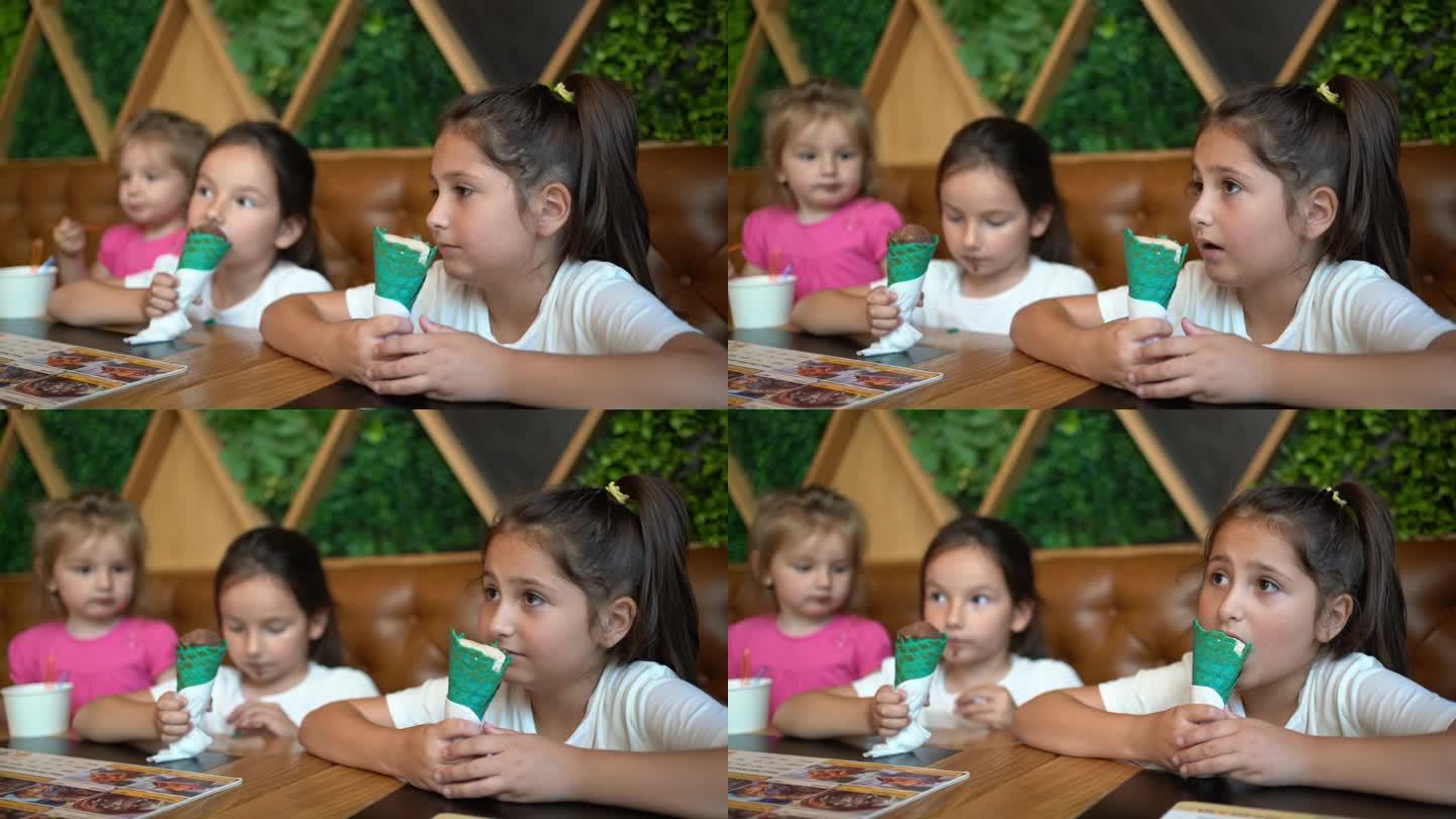 姐妹们在自助餐厅用绿色的甜筒吃冰淇淋
