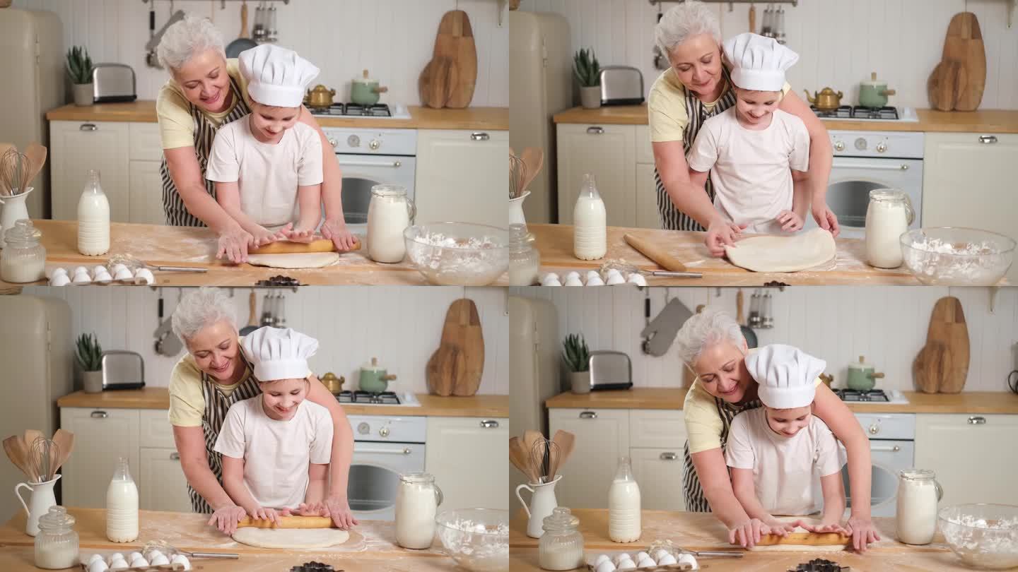 快乐的家庭在厨房。奶奶和孙女孩子一起在厨房做饭。奶奶教小女孩擀面烤饼干。家庭团队合作帮助家庭世代相传
