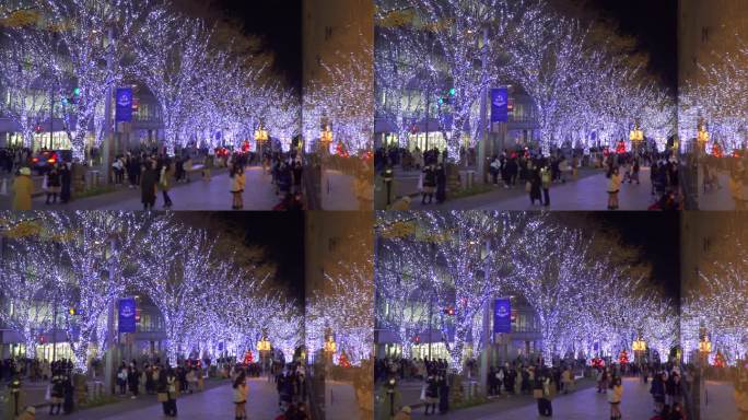 人们漫步在屋崎坂的圣诞彩灯旁