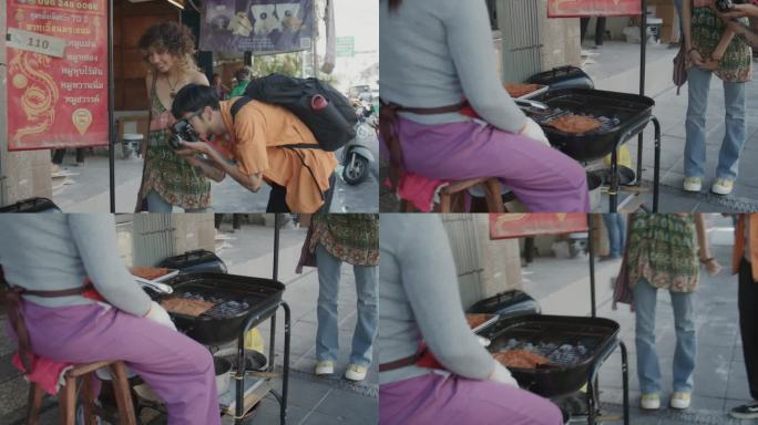 在曼谷唐人街，一对亚洲夫妇在一起，男性在拍街头小吃。