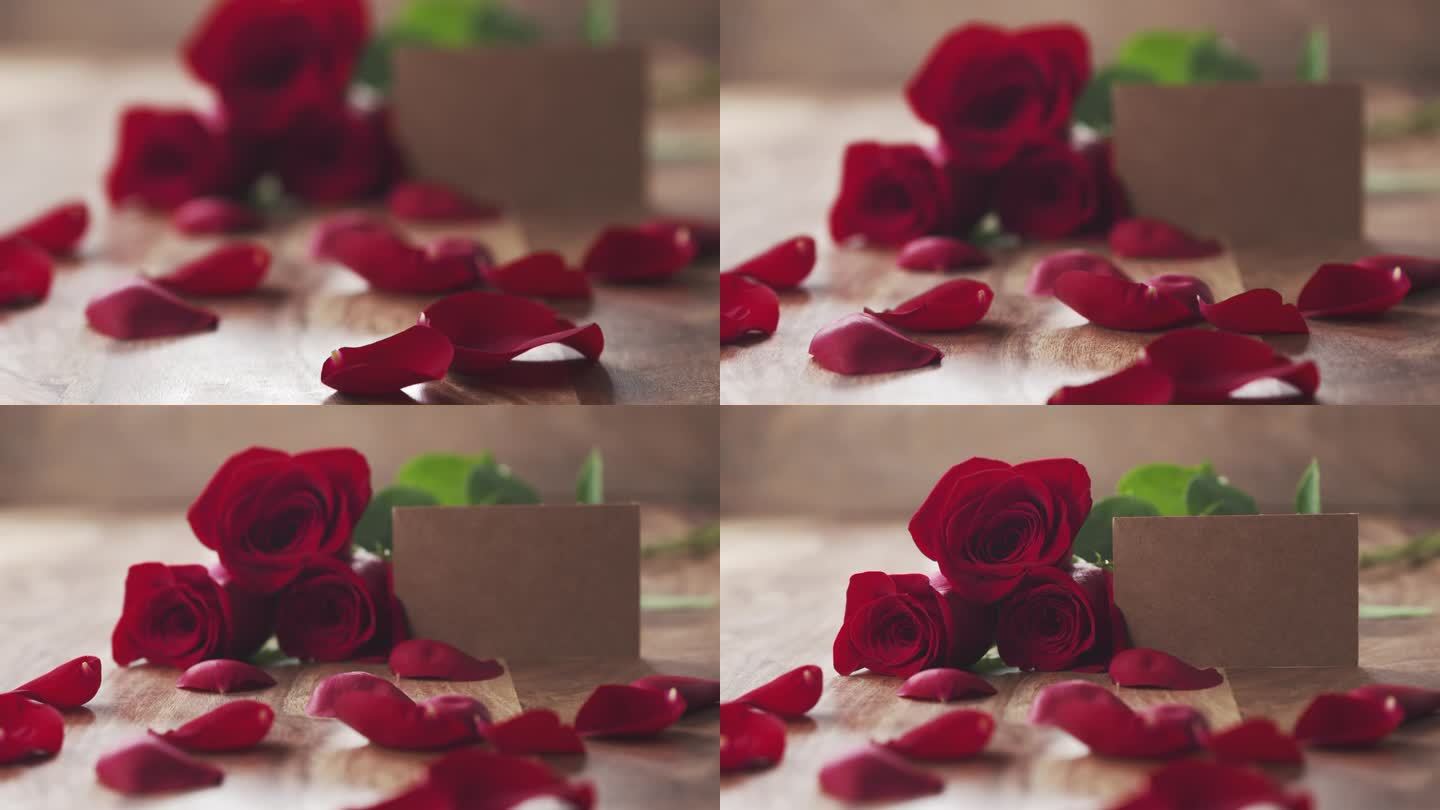 三朵红玫瑰与空纸卡放在旧木桌焦点拉