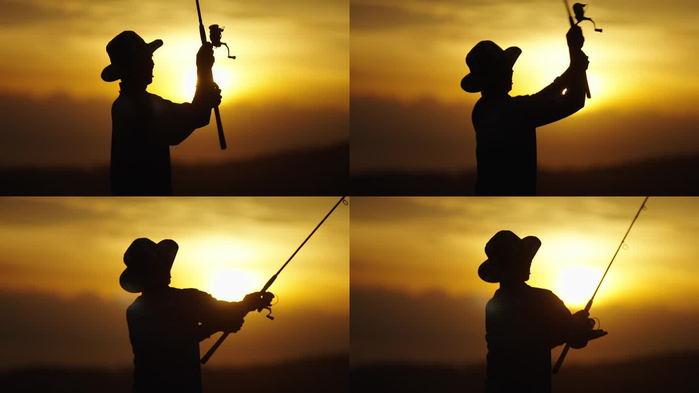 渔民的剪影独自休闲与鱼竿户外捕捉生活鱼在日落