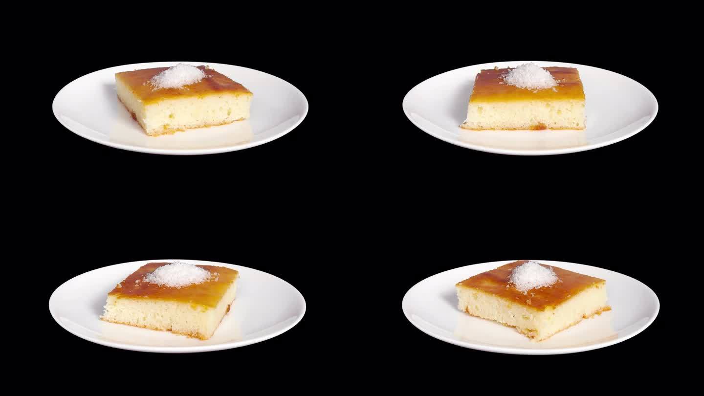 一个美味的土耳其甜点称为“Revani”在一个白色的盘子上:一个库存视频与无缝旋转和Alpha通道