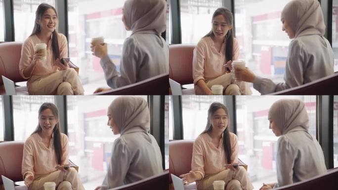 一名亚洲穆斯林妇女在咖啡店与朋友交谈