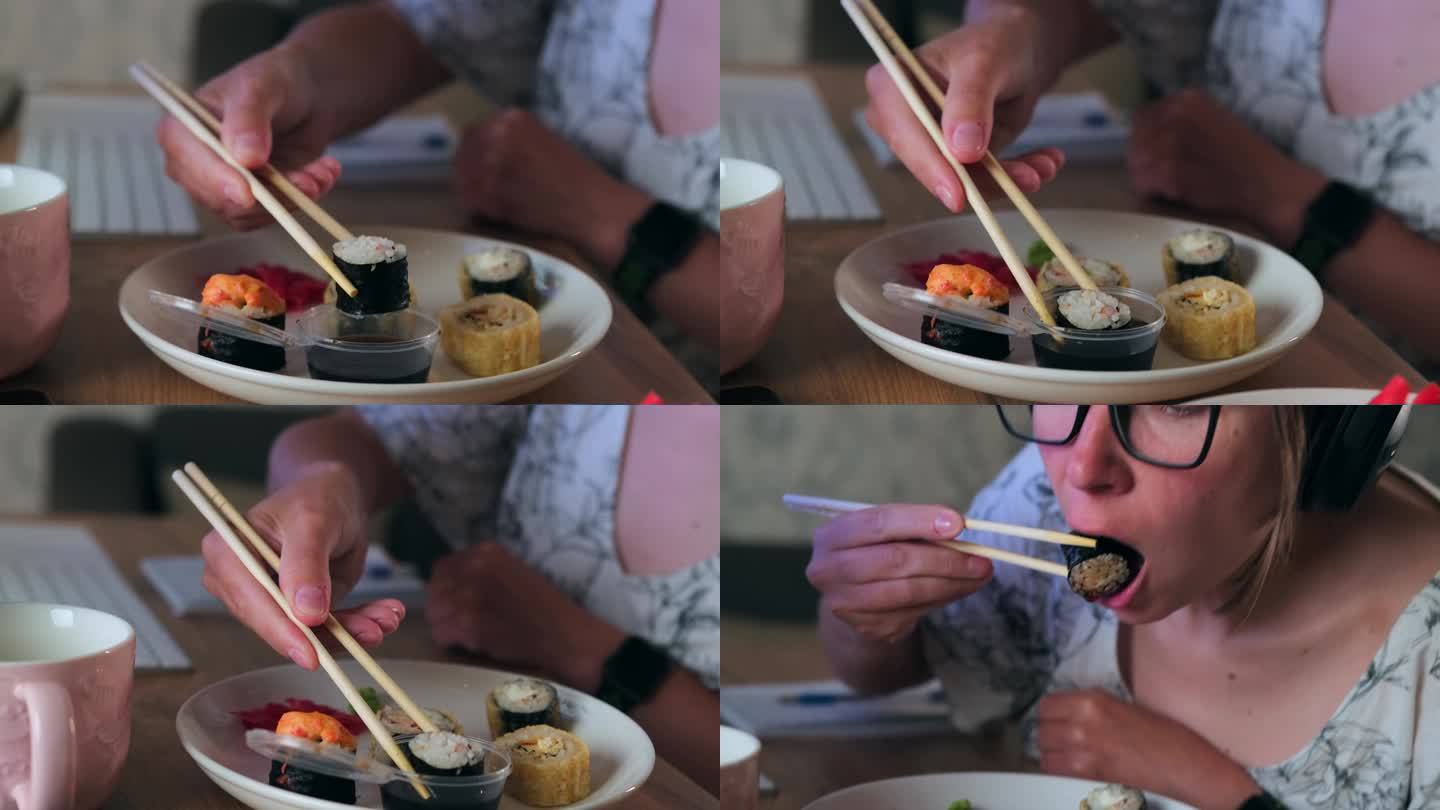 年轻女子用中国筷子蘸酱油卷
