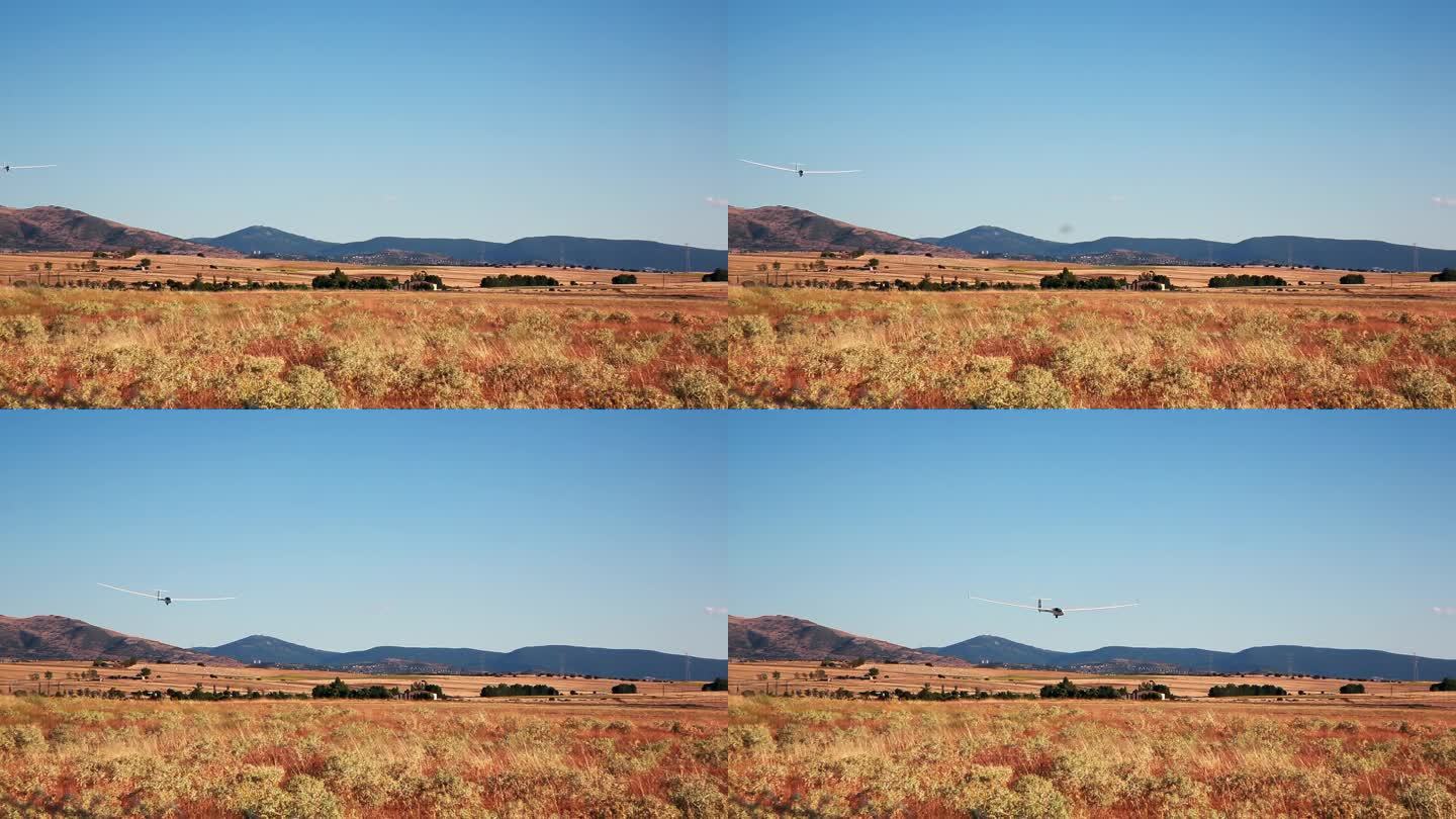 滑翔机进场降落在山的背景