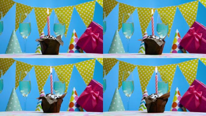 出生日期。庄严的巧克力蛋糕和燃烧的蜡烛。背景祝贺生日快乐，周年纪念明信片配香槟酒。蜡烛松饼