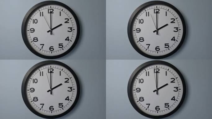 白色挂钟上的白色钟面特写，箭头显示14:00或02:00
