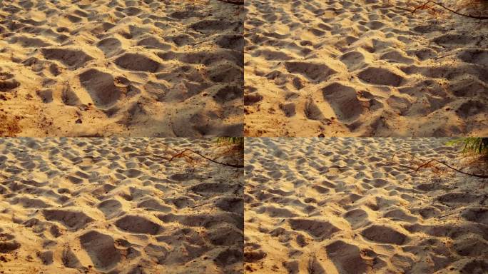 夕阳下沙滩上细沙的特写。温暖的夜晚气氛。夏季。海上度假。抽象的背景。纹理自然表面。没有人。波模式。自