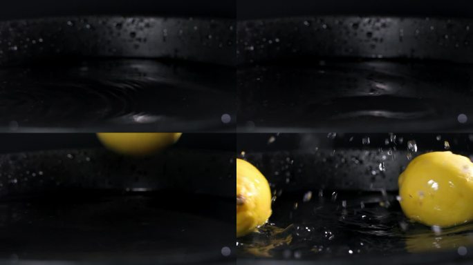 健康的水果，成熟的维生素柠檬落入一盘水中，水花散落在黑暗的背景上，特写