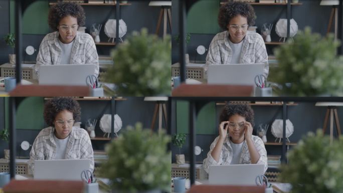 压力很大的非裔美国女性用笔记本电脑工作，然后坐在办公室里表达沮丧和愤怒