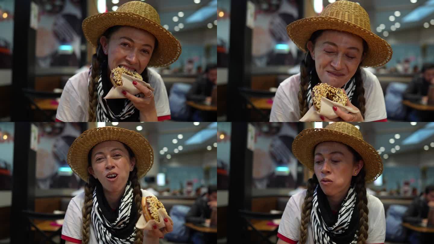 中年妇女在机场餐厅吃甜甜圈