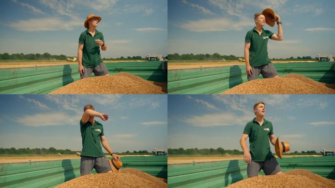 在Sunhat的SLO MO农民一边擦拭汗水一边检查拖车里装满的小麦