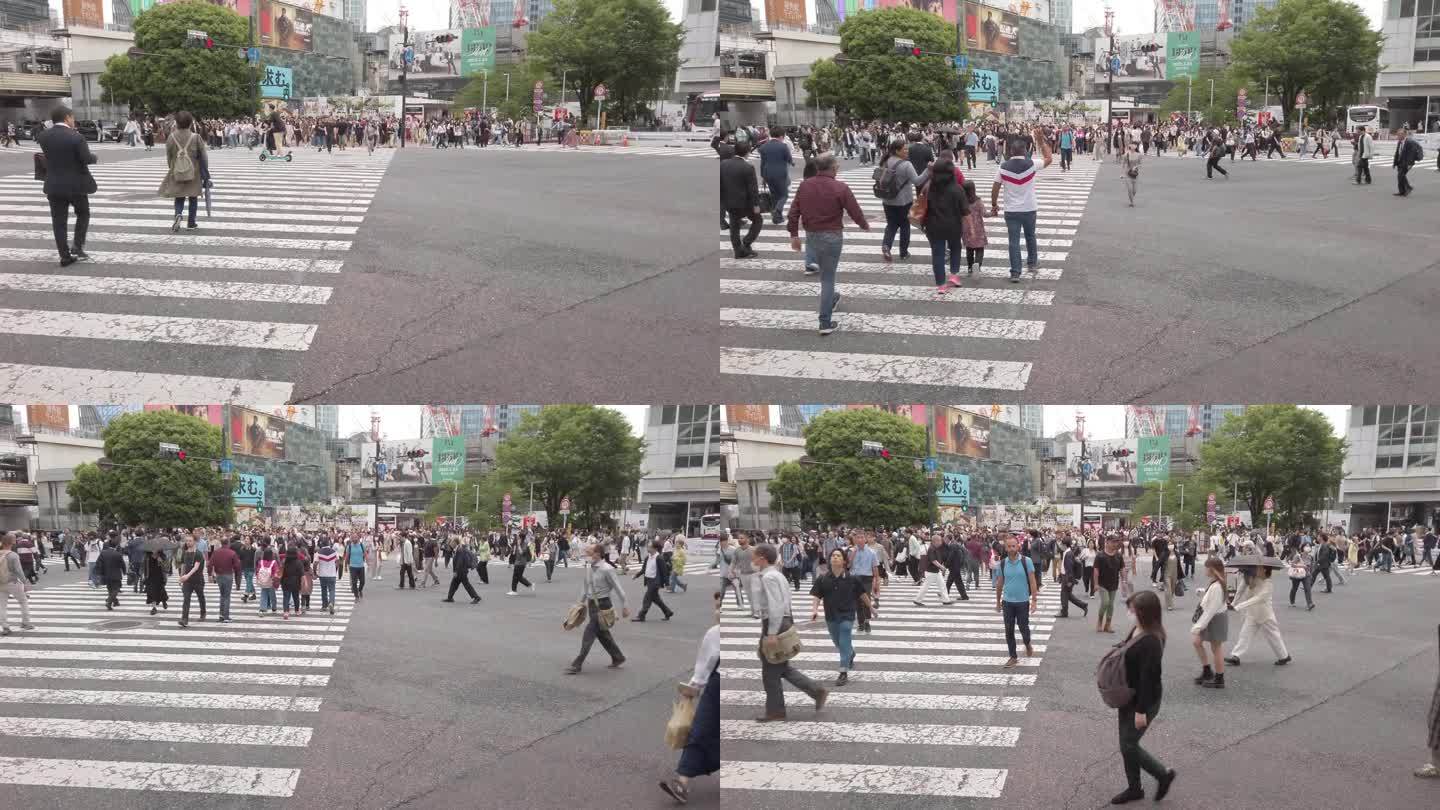 倾斜三角帆射击。日本东京，行人穿过涩谷十字路口