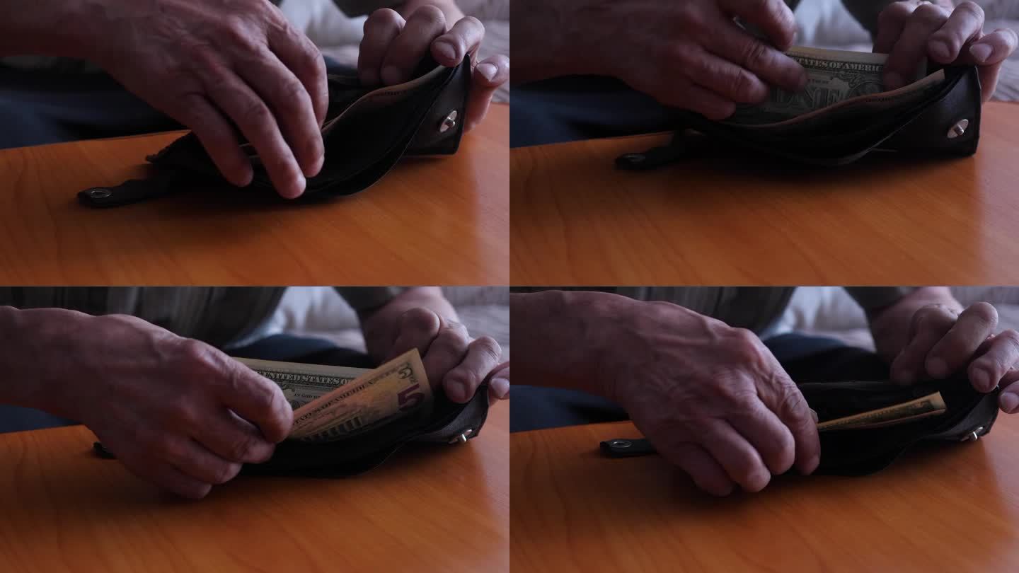 一个男人的手打开钱包的特写，里面装着最后的钞票。一个老人的财政开支的概念，在破产的边缘