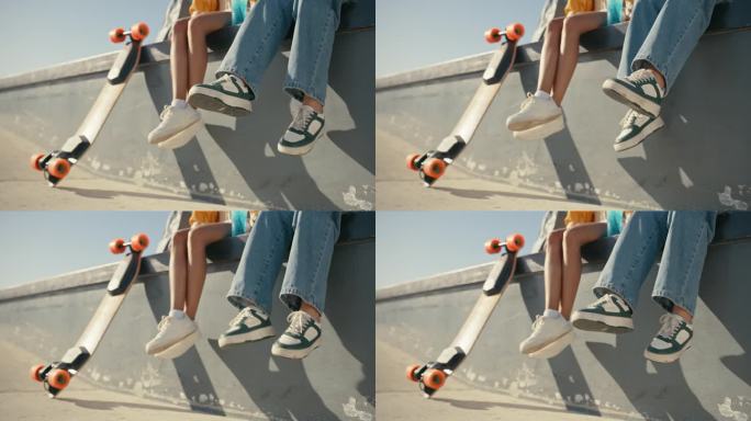 鞋，让滑板的年轻人和滑板在城市的一块滑板上自由地结合在一起。滑冰，休息和屋顶上的城市建筑坐在墙上的腿