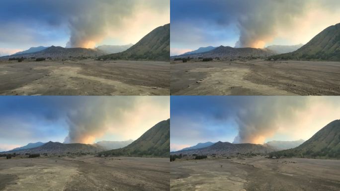 空中无人机拍摄的火山喷发日落场景，被云、雾和烟包围的Bromo火山与塞默鲁山、Batok和Widod