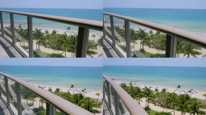 从迈阿密豪华度假胜地高层公寓的露台上欣赏迷人的景色。热带海滩与异国情调的棕榈树，大西洋清澈的海水和白