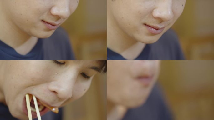 一个满脸痣的亚洲男人的特写镜头，开心地吃着一片三文鱼生鱼片