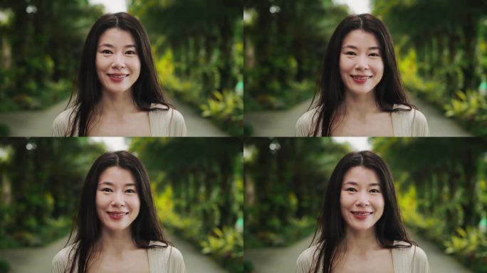 年轻的亚洲妇女看着相机近距离的肖像。美丽的日本或中国女孩在绿色背景下摆姿势的头部和正面视图。凉爽的生