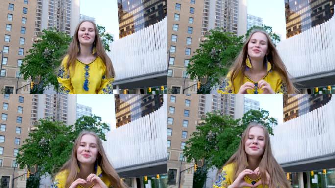 可爱美丽的金发女孩年轻女子看着框架，用她的手做一个心在白绿背景上的黄色衬衫快乐的街头爱和平在乌克兰快