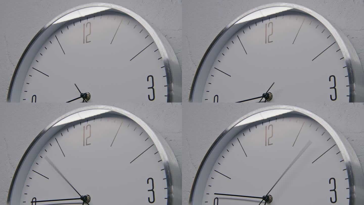 白色手表与金属框架悬挂，显示时间