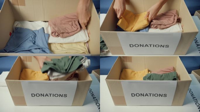 快乐的亚洲少女志愿者在慈善基金会工作时，将衣服产品装入捐赠纸板箱。社工，冠状病毒和隔离。特写镜头。