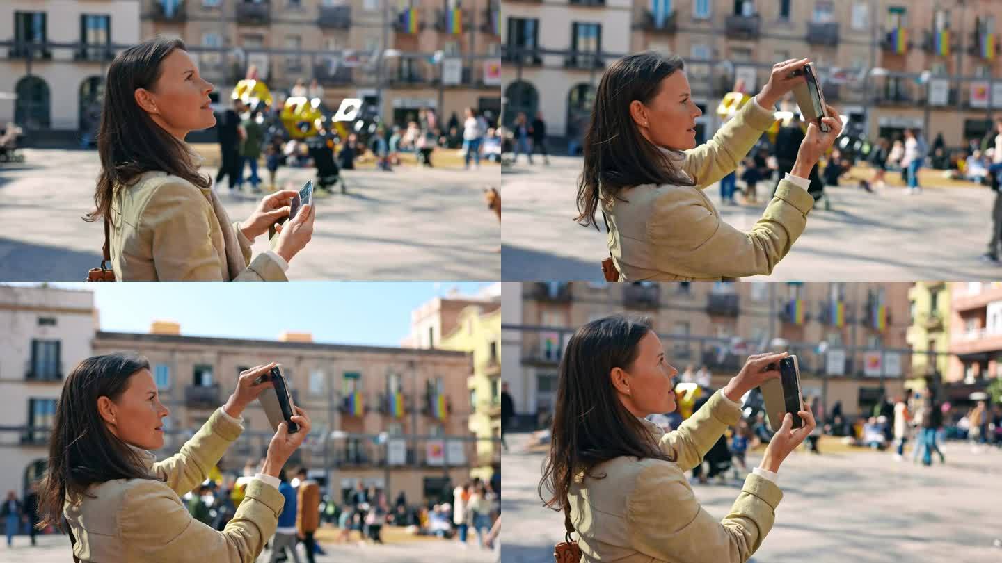 女游客在巴塞罗那观光时用智能手机拍照