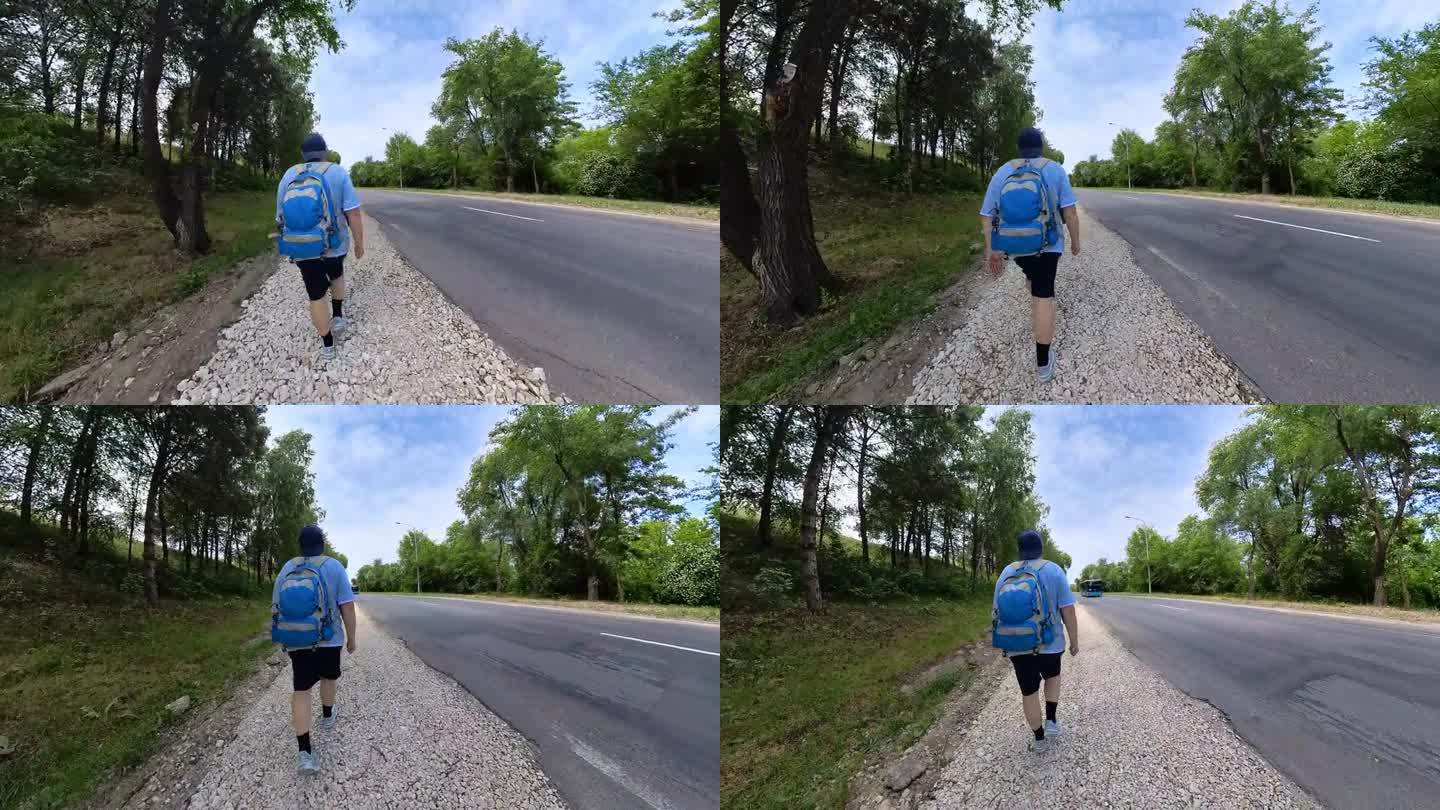 夏日里，中年男子走在森林边缘的高速公路旁。